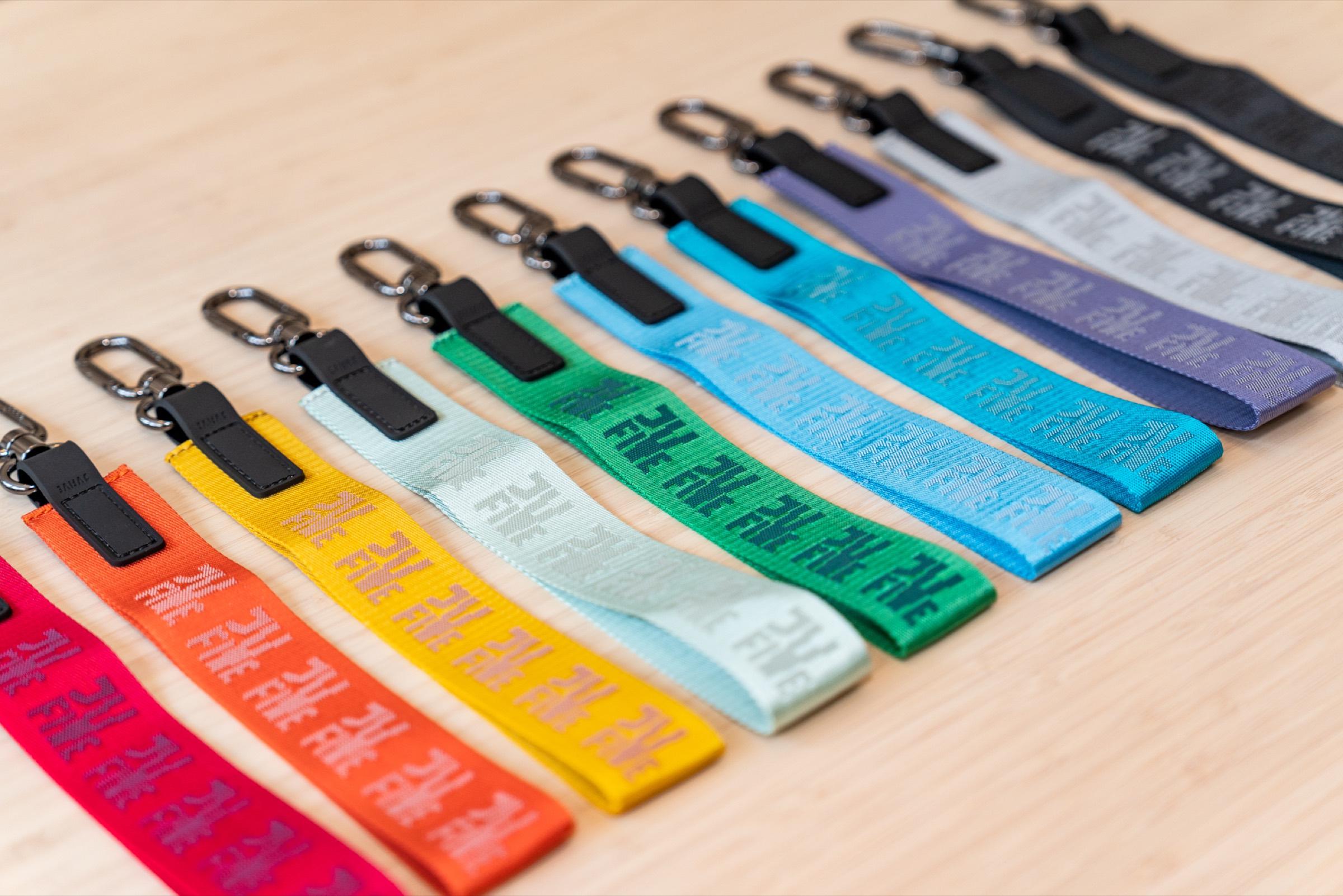 Every Controller Keystrap colorway fanned out in a line, from red and orange spice through the greens and blues to silver and blackout
